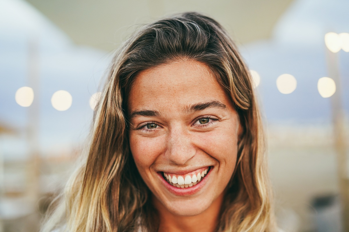 Patient showing bright white smile after professional teeth whitening